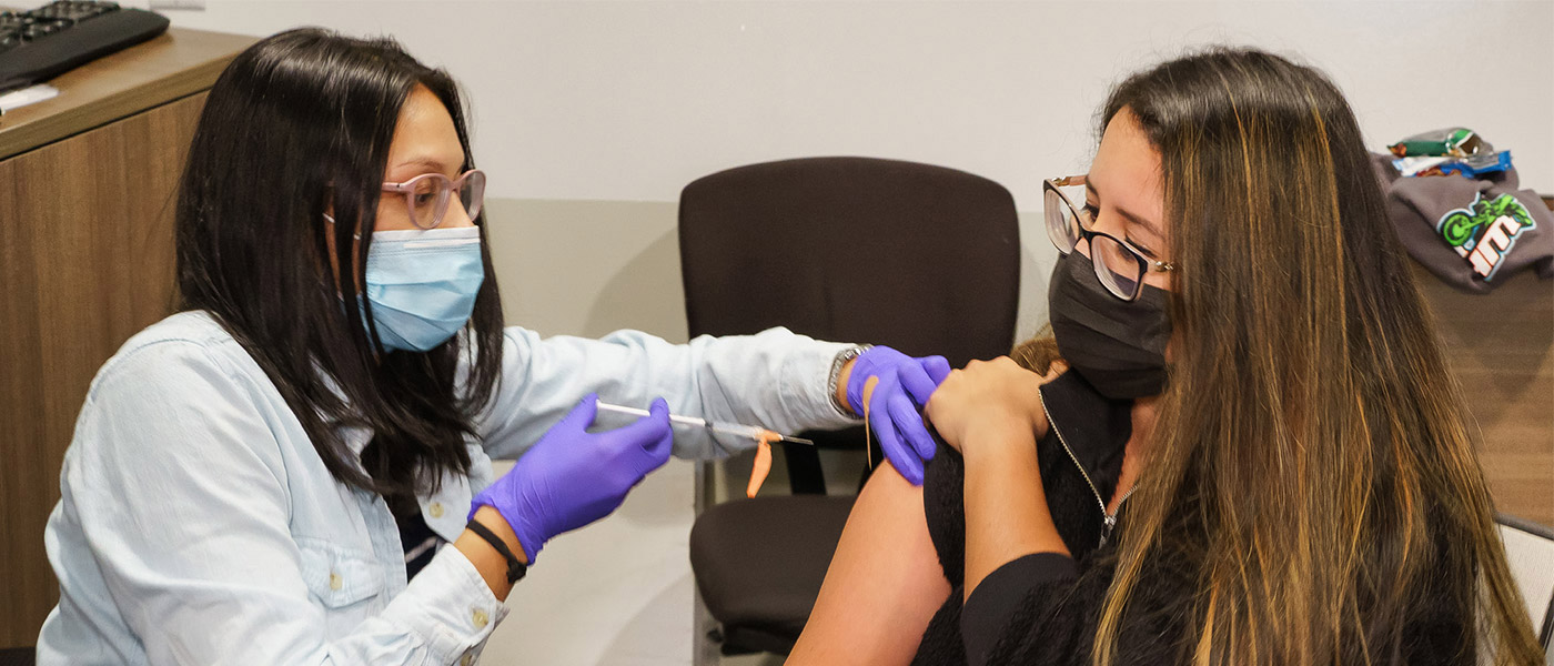 A nurse administering a covid vaccine